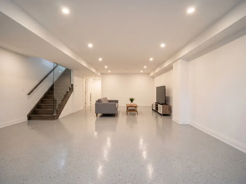 Sealed basement floor with solid-color epoxy coating in a finished WV home basement