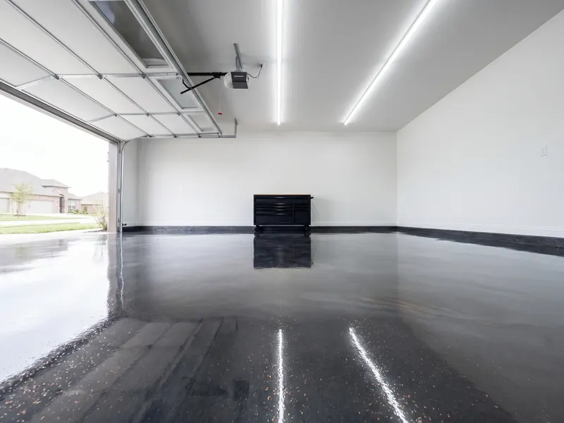 Epoxy flake garage floor with charcoal base and grey-and-blue flake broadcast